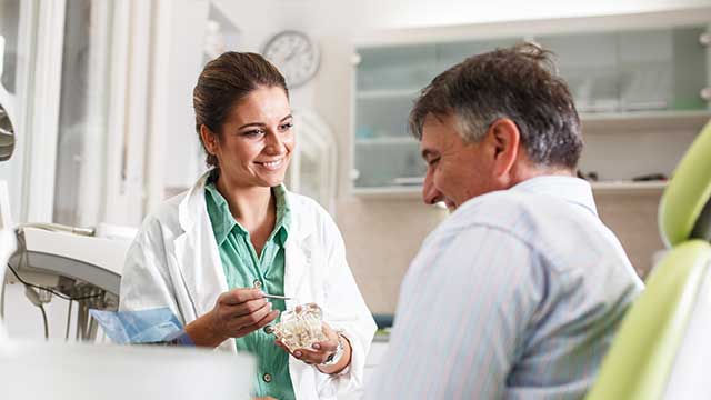 Dentist with patient in dental office