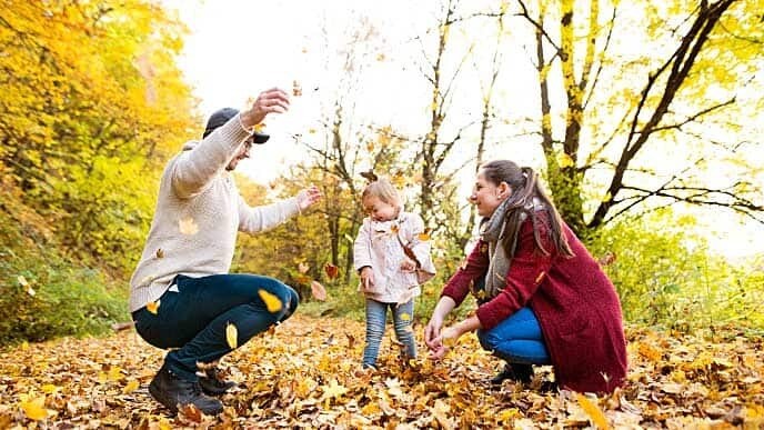 family playing with leaves
