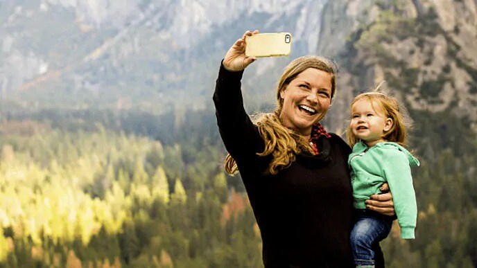 mother smiling with child on a hike