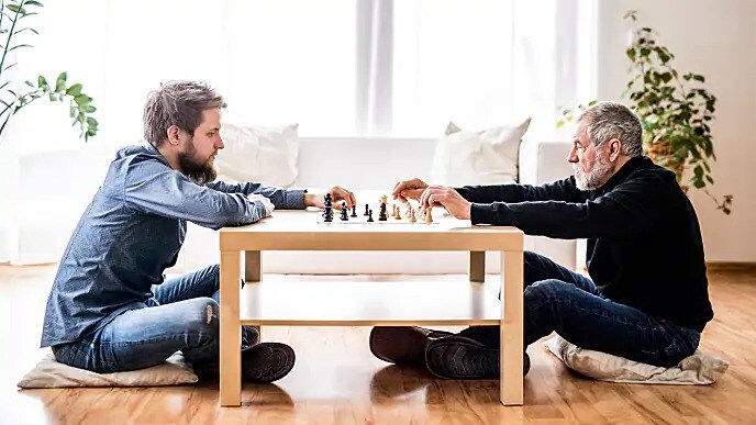 father and son playing chess