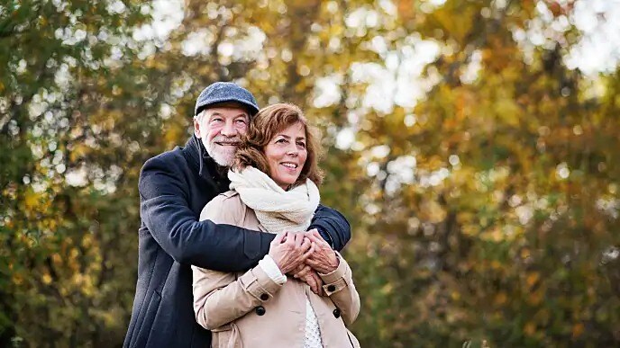 older couple smiling on a hike