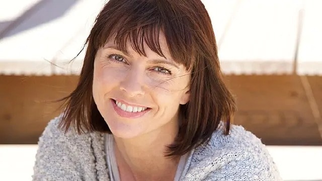 Woman with clean dentures smiling