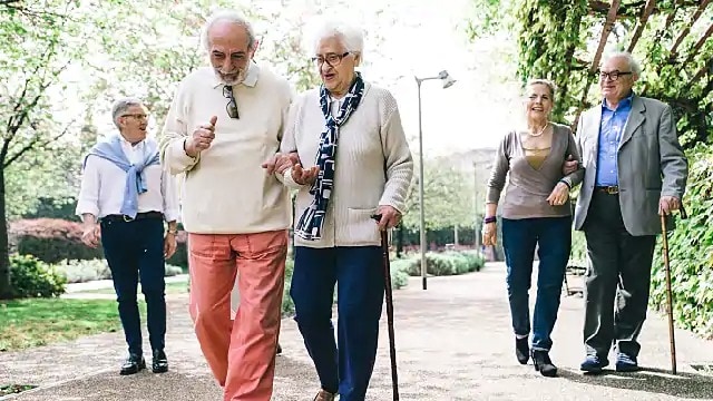 older couple with flexible dentures walking