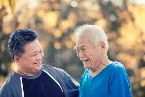 father and son laughing together outside