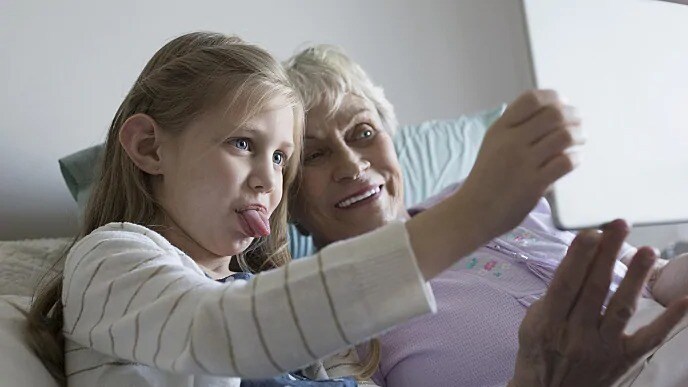 grandmother taking a picture with granddaughter
