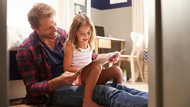 father reading to his daughter