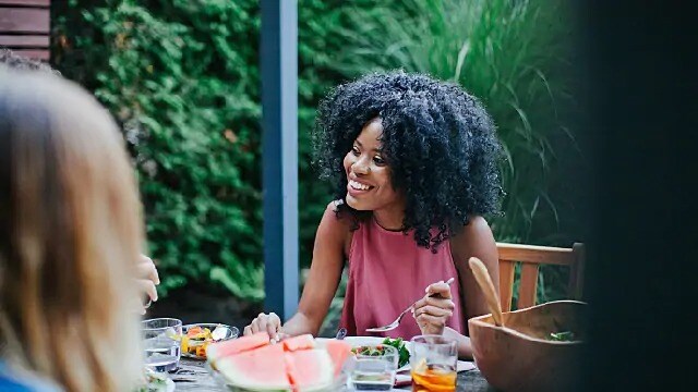 woman smiling while at lunch