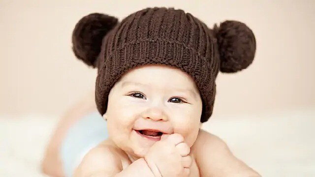 infant smiling after cleft lip surgery