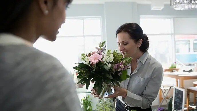 woman smelling flowers