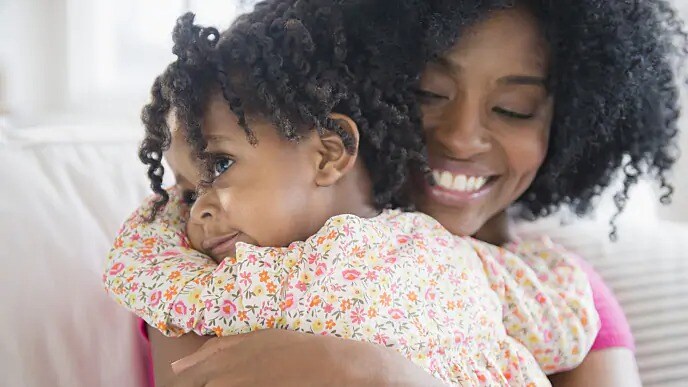 mother holding daughter after dental visit mother holding daughter after dental visit
