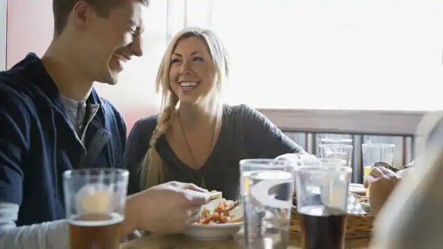 friends are having lunch and drinks happily together