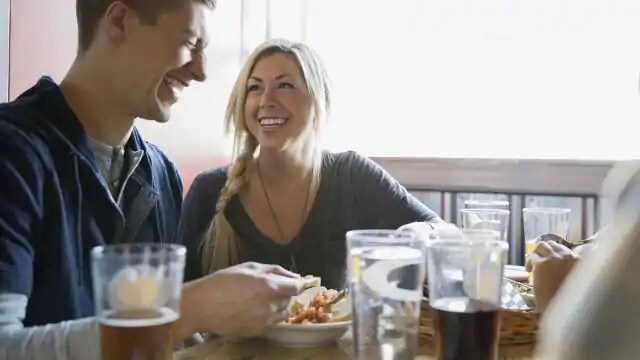 Woman smiling at a man during a meal