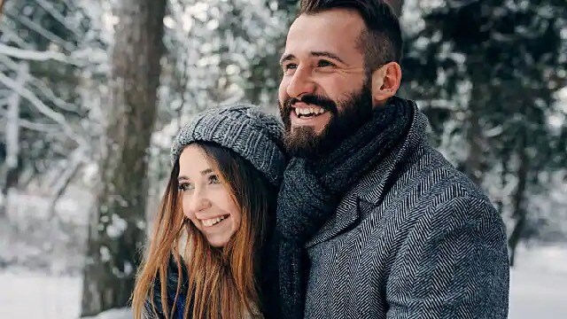 A couple smiling while outside