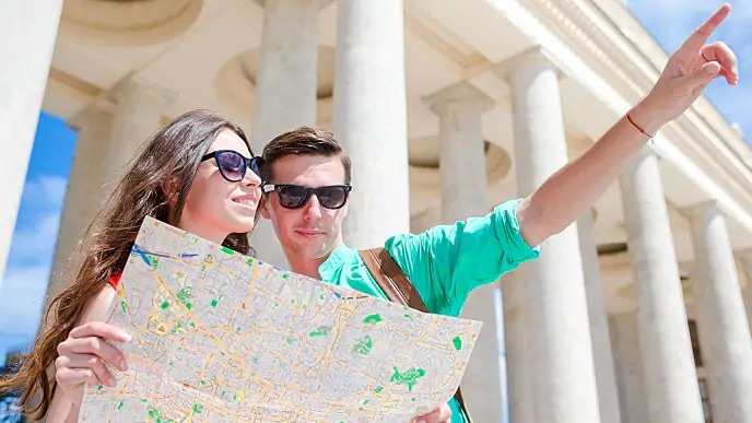 A couple outside looking at a map