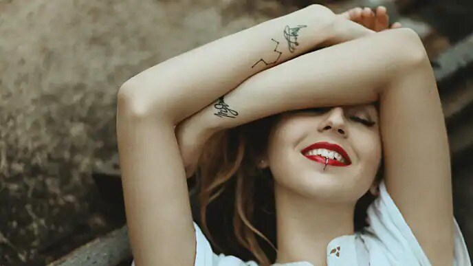 woman with tattoos smiling