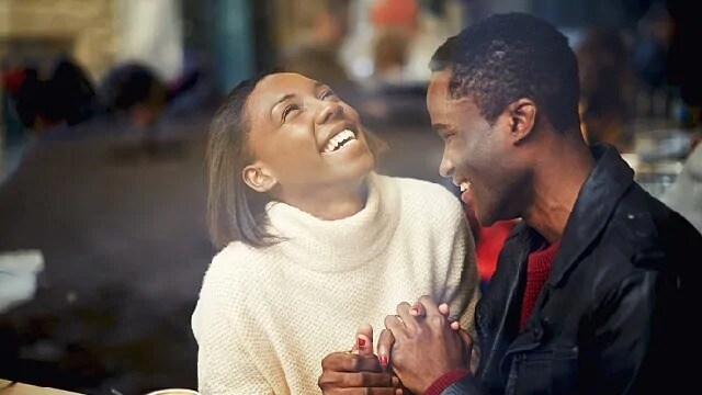 Man smiling and a laughing woman