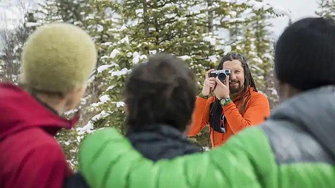 Photographer taking a photo of three people