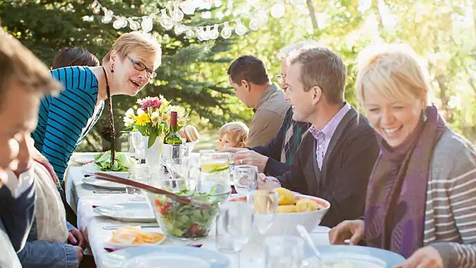 A group of people seated at an outdoor table for a meal