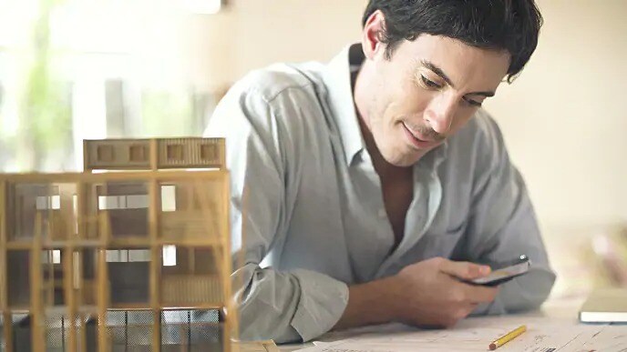 Man looking down at blueprints