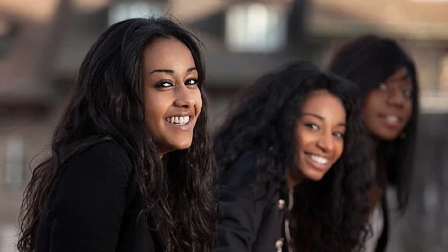 Two women smiling into the camera