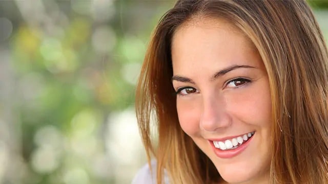A woman with white teeth smiling