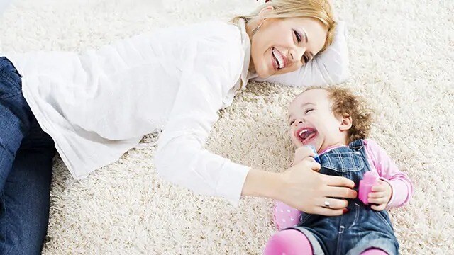 mom and teething infant smiling