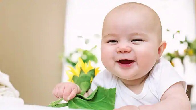 infant smiling while teething