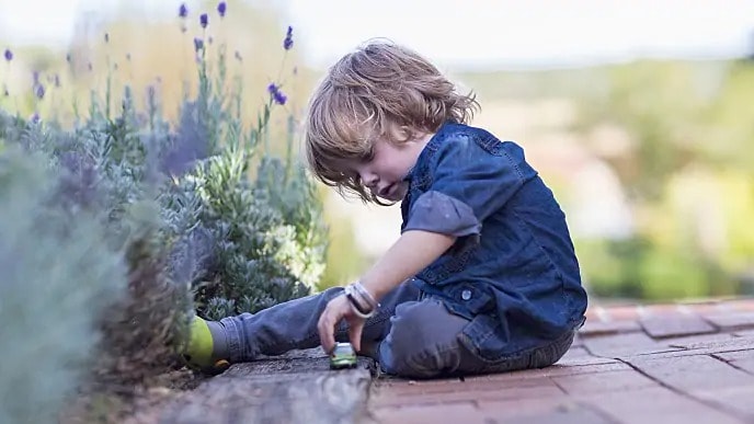 Toddler sitting in a garden