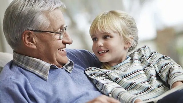 Young child smiling at a grandparent