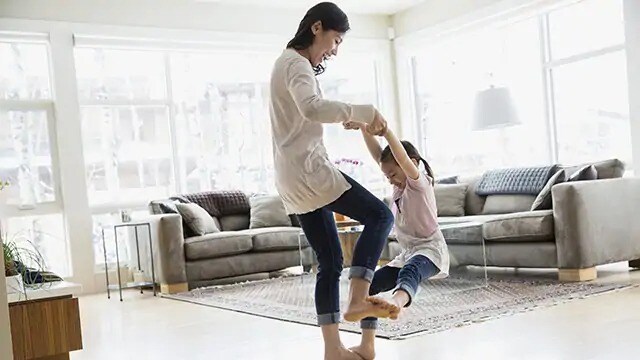 Woman spinning a young girl by the arms