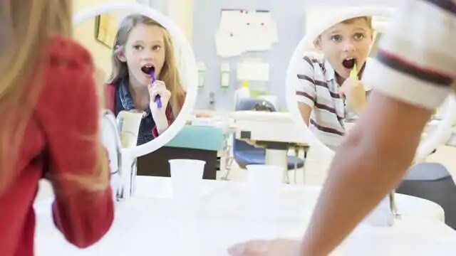 Two children brushing their teeth