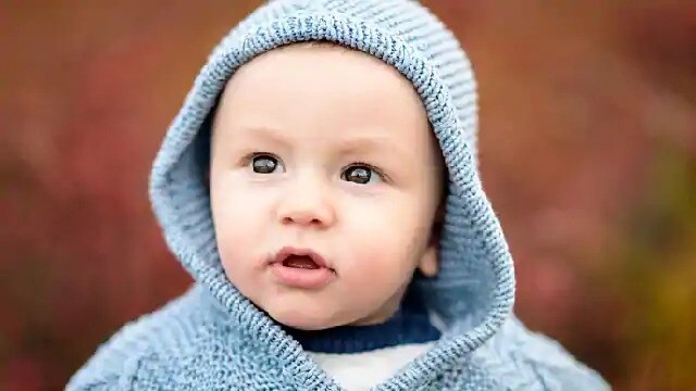 An infant wearing a hoodie