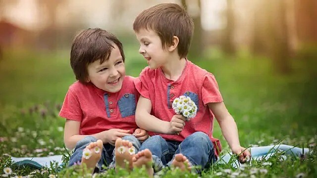 Two children playing among flowers