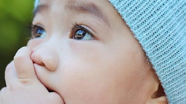 Child with their thumb in their mouth