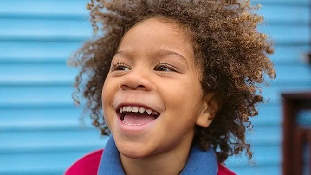 Child smiling showing teeth