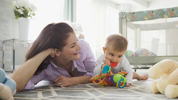 Woman looking at a teething infant
