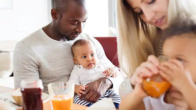 Parents holding children during breakfast