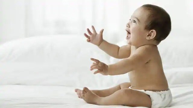 A smiling infant sits