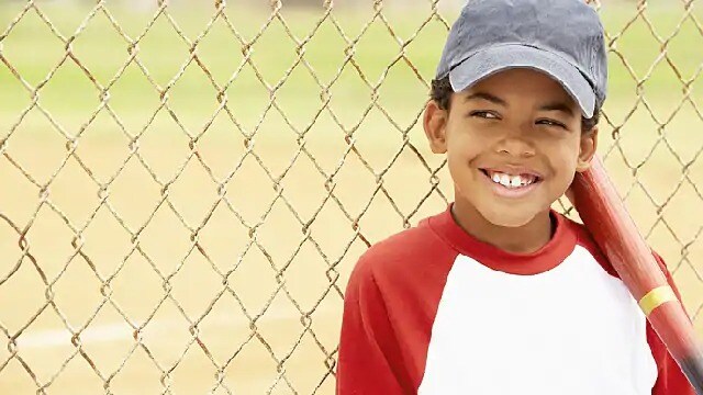 smiling kid at baseball game