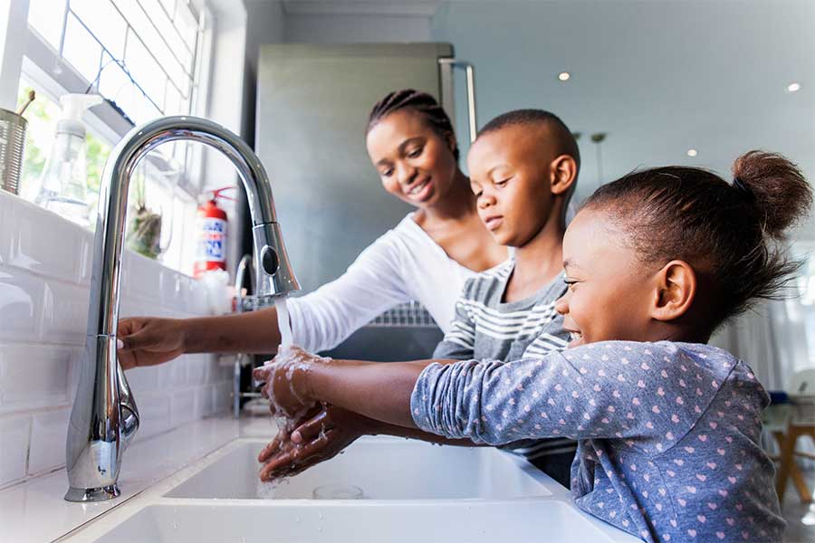 Family washing hands together Family washing hands together
