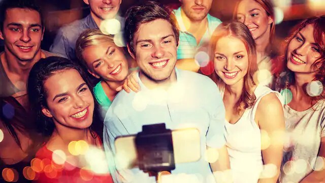 group of people smiling without teeth grills