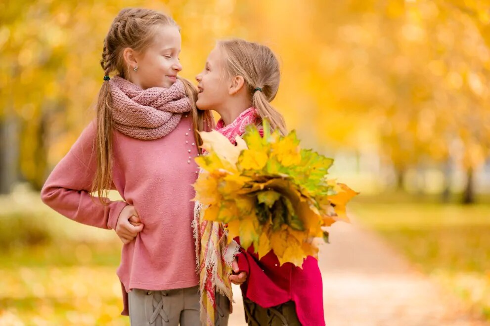 girls walking through the park
