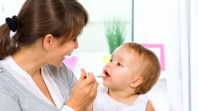 Parent Feeding Child Healthy Snack for Good Breath