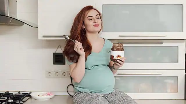 pregnant woman eating a tooth-friendly snack