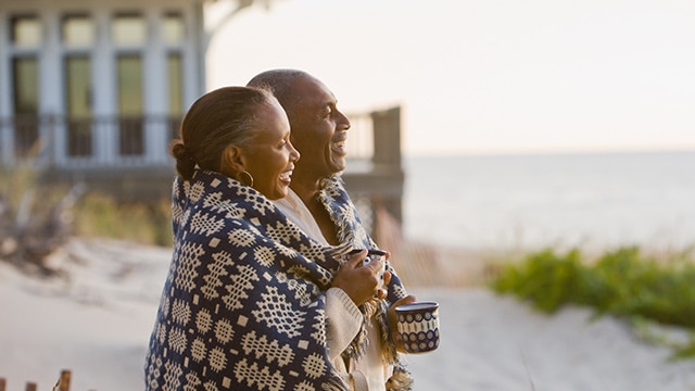 Senior African American couple wrapped in blanket