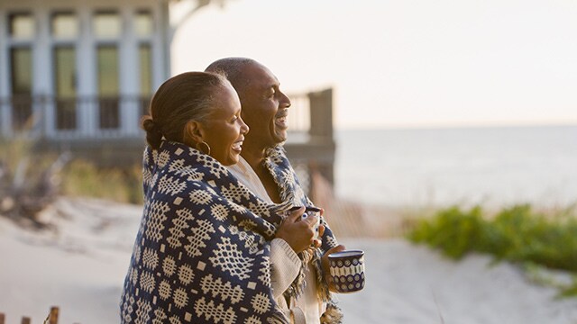 Senior African American couple wrapped in blanket