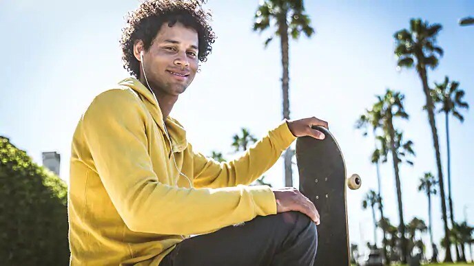 man with braces smiling at the skate park