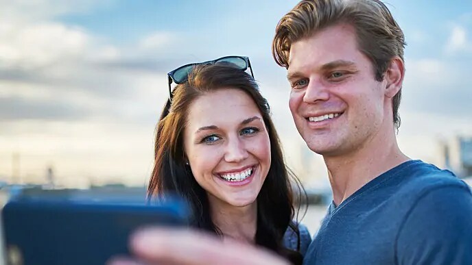 A smiling couple taking a selfie