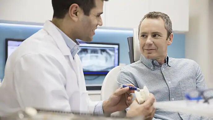 dentist showing patient new technology