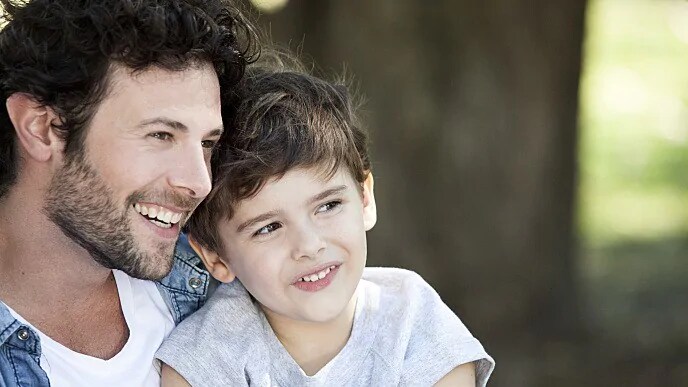 father and son smiling together after trip to dentist